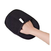 Black mesh pet hair remover glove with hand inserted. Comfortable and easy to use for grooming pets.