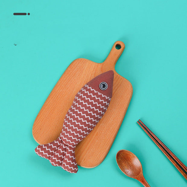 Red Cat Toy Funny Cat Linen Fish Pillow displayed on a wooden board, showcasing its zigzag pattern and durable linen material.