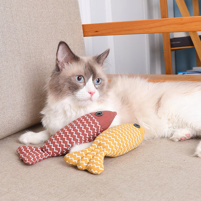 Cat lounging with two Cat Toy Funny Cat Linen Fish Pillows in yellow and red, ideal for biting and interactive play.