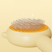 Pet grooming brush with orange base and white bristles on a beige background