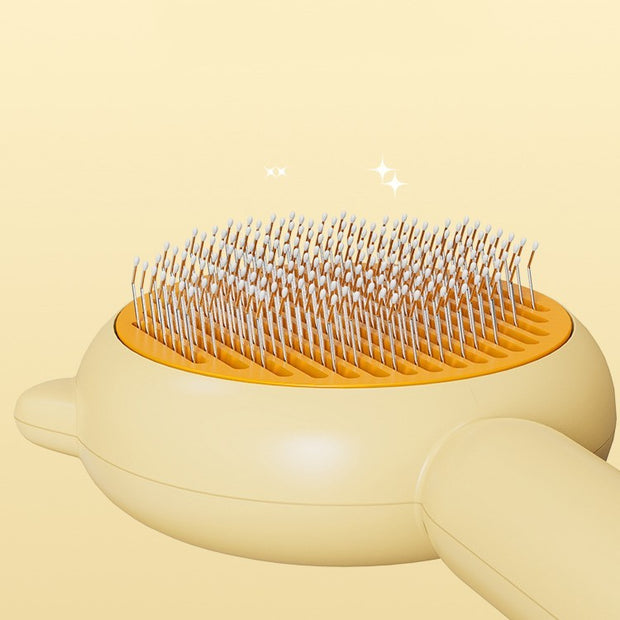 Pet grooming brush with orange base and white bristles on a beige background